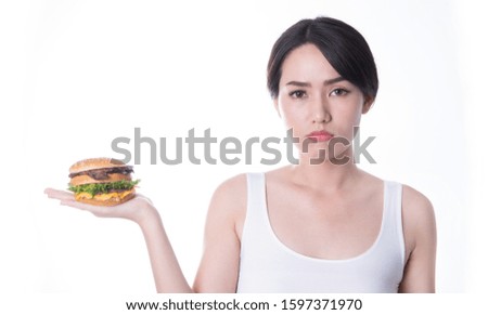 Beauty asian women eating burger isolated on white background. fast food to fat. Healthy junk food Concept. Focus burger on her hand.