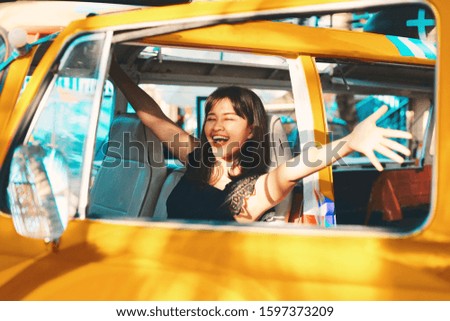 Smiling Asian woman in vintage car,Young woman driving car on sunny day.