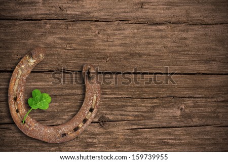 Blackboard with four-leaved clover and a horse shoe Royalty-Free Stock Photo #159739955