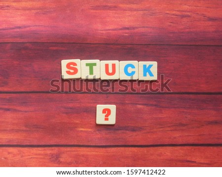 Word Stuck ? on wood background