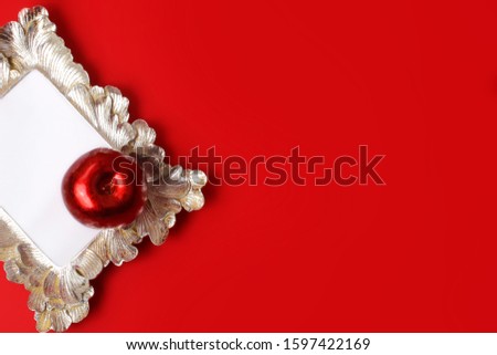 Beautiful rd metallic apple on the vintage frame.Backdrop for design.Festive concept.Good background for different banners.