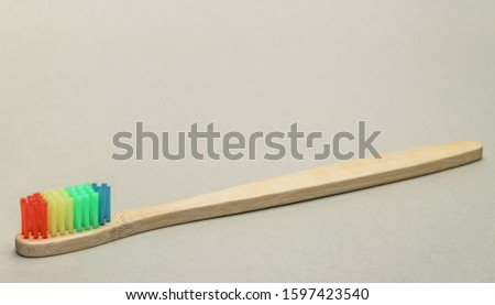 Beautiful wooden  toothbrush  on a gray background.
