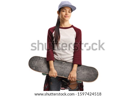 Skater girl holding a skateboard and smiling isolated on white background