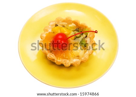 Cake with a cherry on a yellow plate
