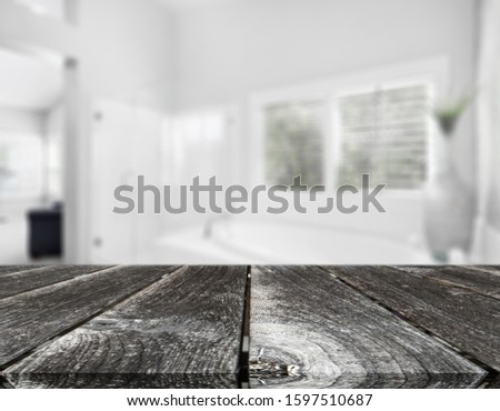 Wood tabletop on blur bathroom background, design key visual layout