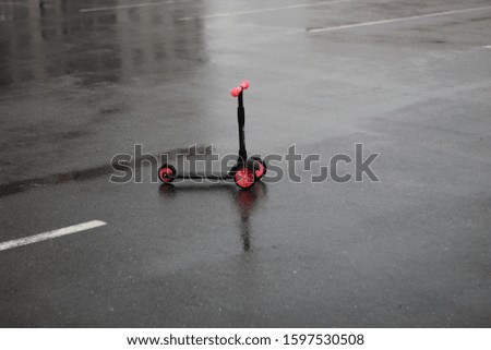 children's pink scooter on the asphalt