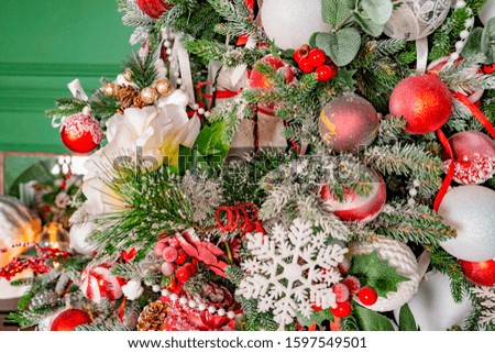 Beautiful Decorated christmas tree on green background. Christmas toys decorations on a spruce.