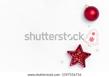 New Year and Christmas composition from red balls, white stars, chrismas tree, deer on white paper background. Top view, flat lay, copy space Royalty-Free Stock Photo #1597556716
