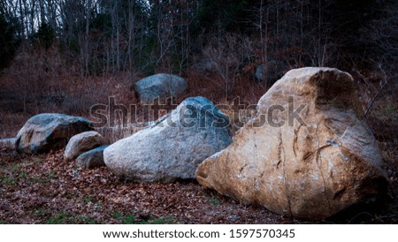 Old boulders in parking lot on Cape Cod