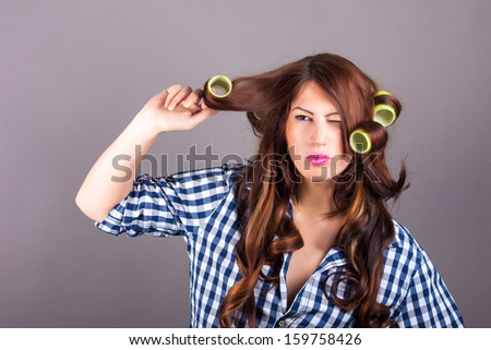 portrait of attractive girl with curlers