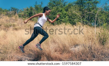 african american woman having exerice with trail running at natural mountain