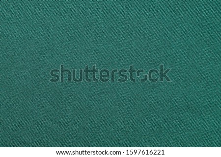 Top view of Beautiful cloth fabric texture background of green dress. Soft surface detail with wave and motion. Decorative, fashion concept with copy space for text.