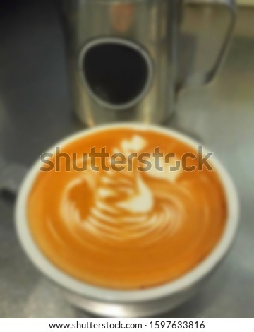 Blurred abstract background of coffee latte art in coffee shop.