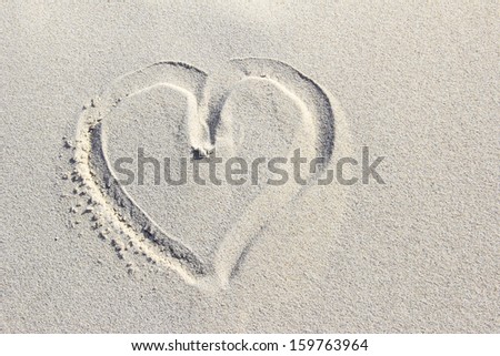 Heart painted in the sand of a dune