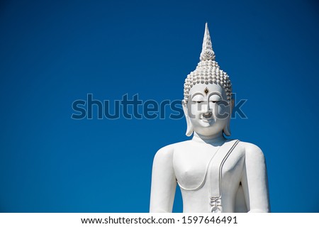 outdoor Thailand landmark beautiful buddhism architecture silver white buddha statues antique meditation in temple have copy space and blue sky background.