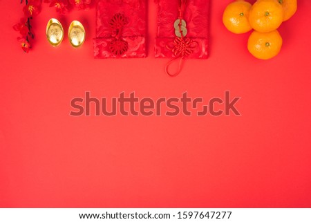 Chinese new year festival concept, flat lay top view, Happy Chinese new year with Red envelope and gold ingot (Character "FU" means fortune, blessing) on red background with copy space for text