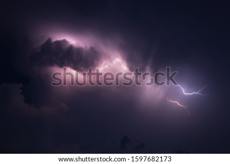 Thunderstorm and lightning in the high sea. Stormy sky with lightning flares. Nature during a sea hurricane. Photo of the night sky in a thunderstorm from the side of a sailing cruise yacht. Thailand