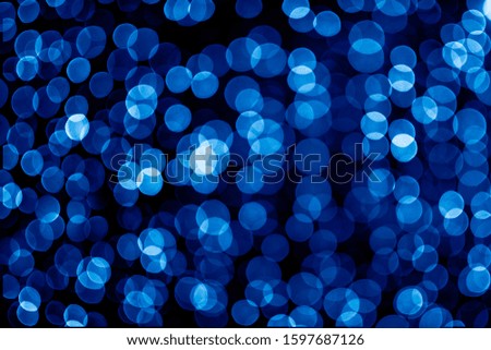 Blurred abstract blue background with bokeh, defocused christmas lights. Holiday christmas concept. Trendy color of the year 2020.