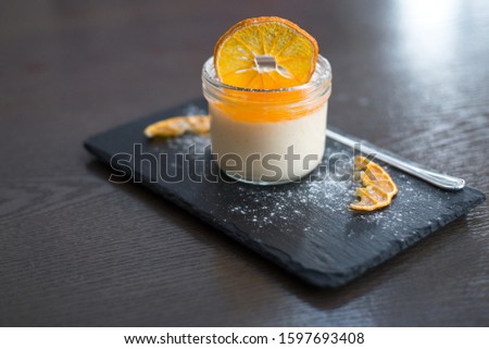 Homemade orange pana cotta with dried slices of mandarin Royalty-Free Stock Photo #1597693408