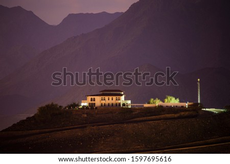 night landscape with a house on the mountain