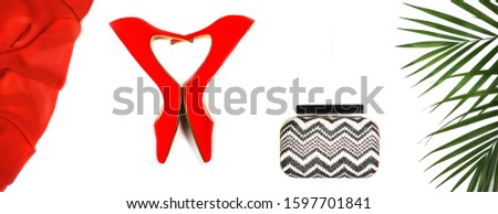 Top view to outfit: red shoes, accessories makeup cosmetics, clutch, tropical monstera leaves on white background isolated. Party Valentine's Day Christmas New Year wedding dinner layout. Flat lay.
