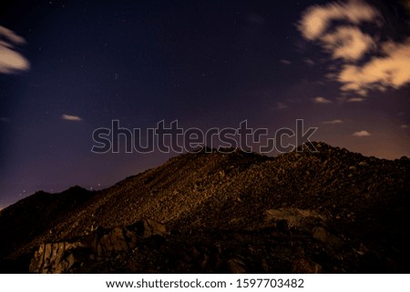 night mountain landscape with sky, clouds and stars