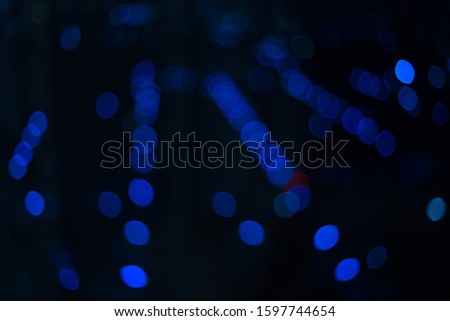Circle Blue bokeh with night lights and a dark background similar to the night time To be used as a background during the night of winter take a photo with lens blurre