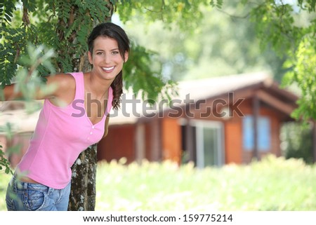 Brunette woman in front of chalet