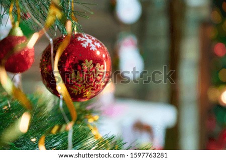 New Year and Christmas concept. Festive photo of decorations for the Christmas tree in the New Year holiday on a background of lights