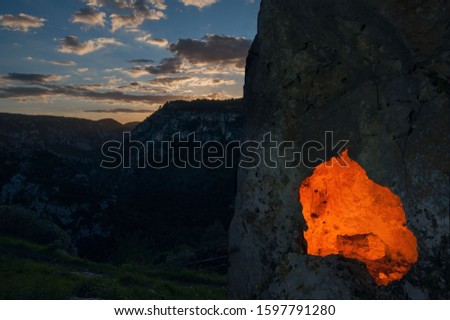 View of a rock-cut tomb by night in the necropolis of Pantalica, Sicily