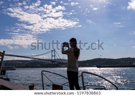 woman taking photos of İstanbul city at Ortakoy
