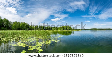Panorama of beautiful summer day on masuria lake district in Poland Royalty-Free Stock Photo #1597871860