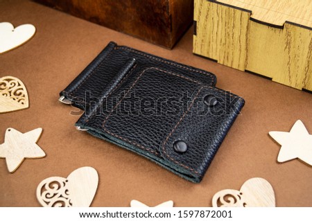 wallet made of genuine leather on the table in the process of packing a gift