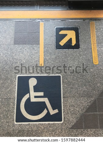 handicap symbol on floor. Top view in train station.