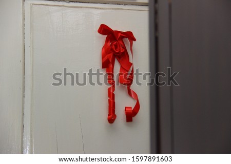 red ribbon at the door of the bride and groom as a symbol of marriage and prayer