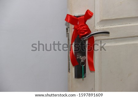 red ribbon at the door of the bride and groom as a symbol of marriage and prayer