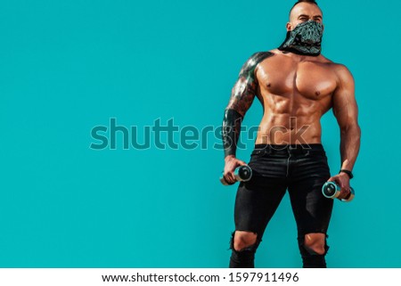 Sportsmen man, fit athlete running in desert with dumbbells. Healthy lifestyle and sport. Fitness concept.