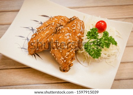 Korean style fried chicken wing with sweet soy sauce on brown wooden background stock photo
