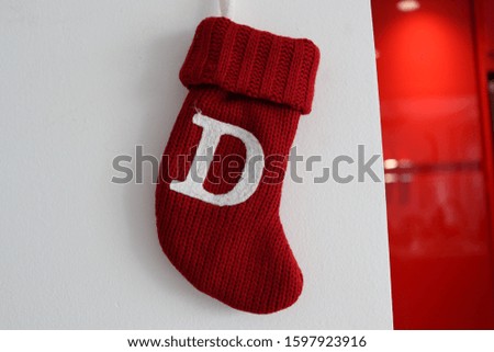Red Christmas Stockings hanging on a wall next to a red kitchen