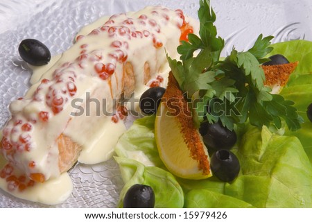 Fish decorated with salad on plate