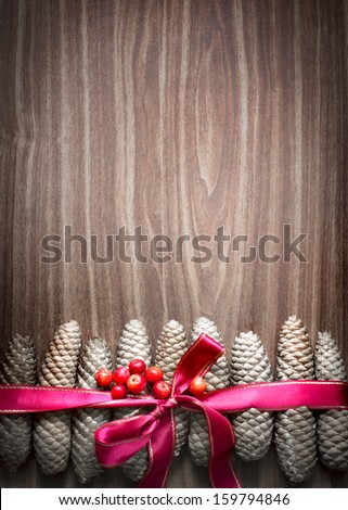 Christmas background with pinecones and a red Christmas ribbon/ Christmas decoration with Pine Cone