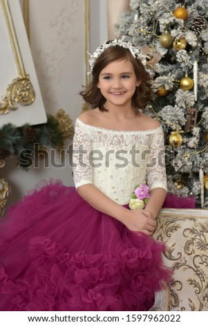 girl in elegant white with a burgundy dress in Christmas