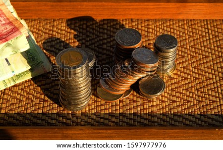 Coin Thai,Pile of coins heap of coins silver gold,Stacks dark brown wood floor background,Investment money concept, Coin stack growing,Isolated