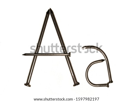            Uppercase and lowercase letter "A" of the Latin alphabet lined with iron nails.                    
