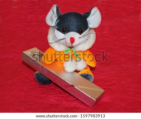Soft toy mouse (rat) with a gift.
