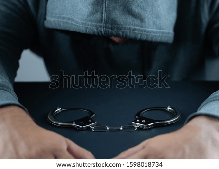 the man in handcuffs at the table, the concept of punishment for the crime