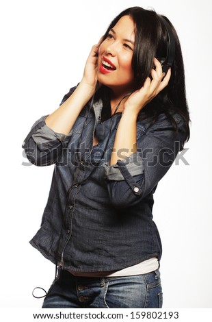 Young bright brunette woman with headphones listening music 