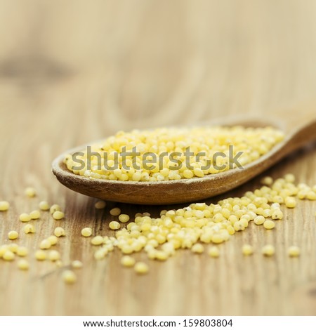 Couscous in a wooden spoon