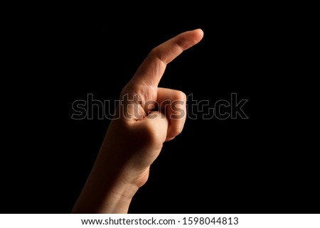 Hand Showing Sign of X Alphabet in American Sign Language (ASL), isolated on black background. Sign language