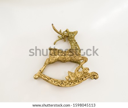 Beautiful golden reindeer toy isolated on white background, little Santa helper decoration, Christmas tree bauble